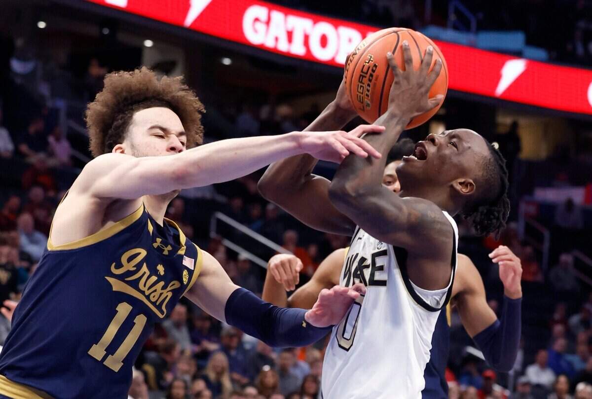 Wake Forest’s Kevin Miller (0) is fouled by Notre Dame’s Braeden Shrewsberry (11) as he drives to the basket during the first half of Wake Forest’s game against Notre Dame in the second round of the 2024 ACC Men’s Basketball Tournament at Capital One Arena in Washington, D.C., Wednesday, March 13, 2024.