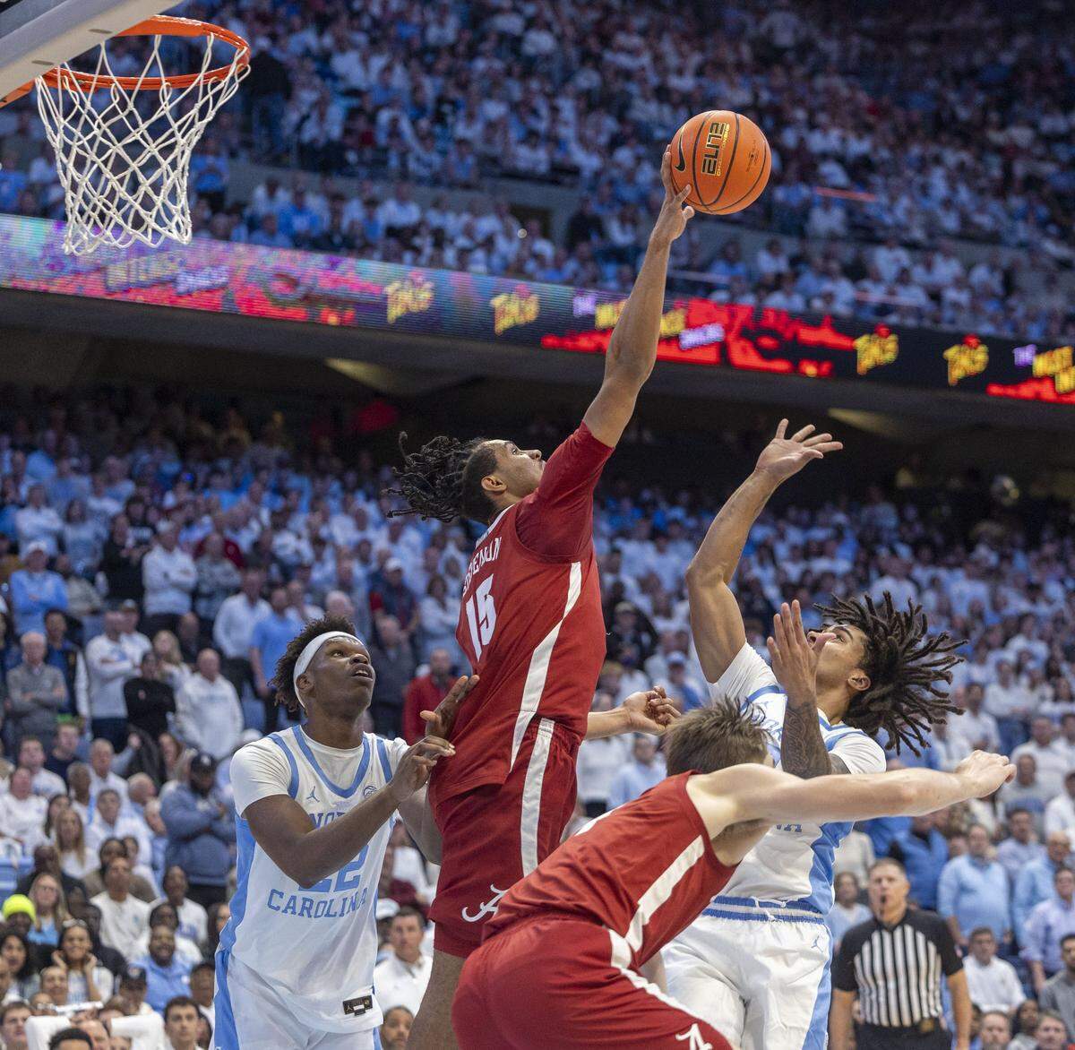 Alabama forward Jarin Stevenson (15) blocks a shot by North Carolina guard Elliot Cadeau (3) in the second half on Wednesday, December 4, 2024 at the Smith Center in Chapel Hill, N.C. Cadeau was held to one point in the Tar Heels’ loss.  