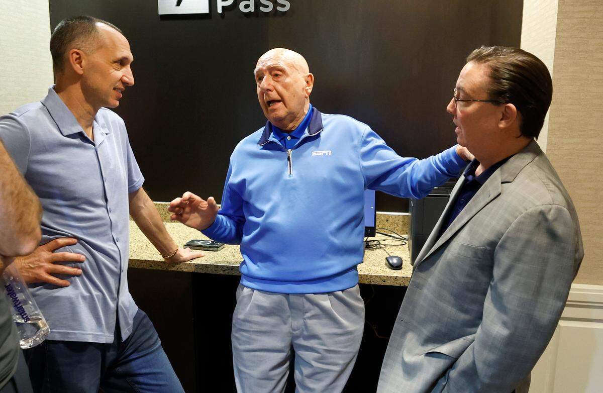 Dick Vitale talks to David Ceisler, VP of Production for ESPN college basketball, left, and play-by-play broadcaster Dave O’Brien in their hotel in Clemson, S.C. Friday, Feb. 7, 2025.