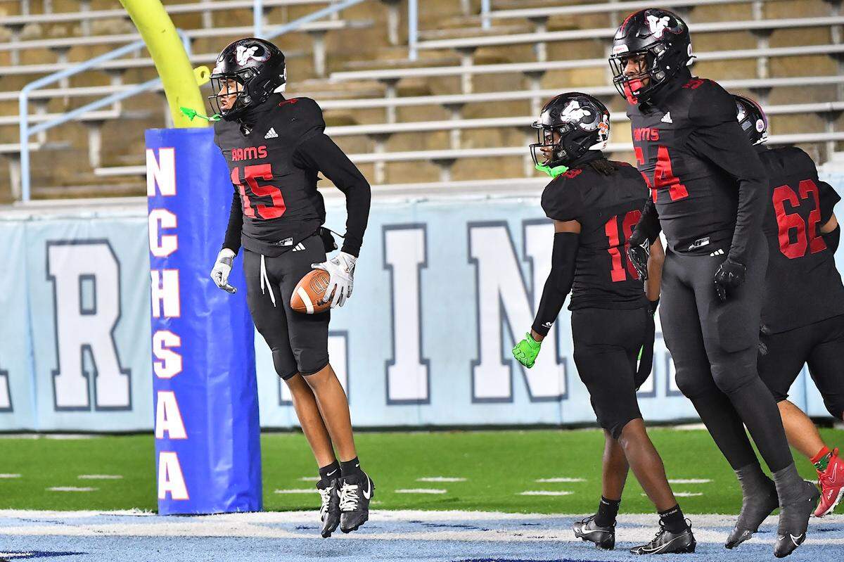 Rolesville wide receiver AJ Roberts (15) celebrates with teammates after scoring the touchdown against Grimsley in the first half. The Rolesville Rams and the Greensboro Grimsley Whirlies met in the NCHSAA 4A football Championship Game in Chapel Hill, N.C. on December 20, 2024.