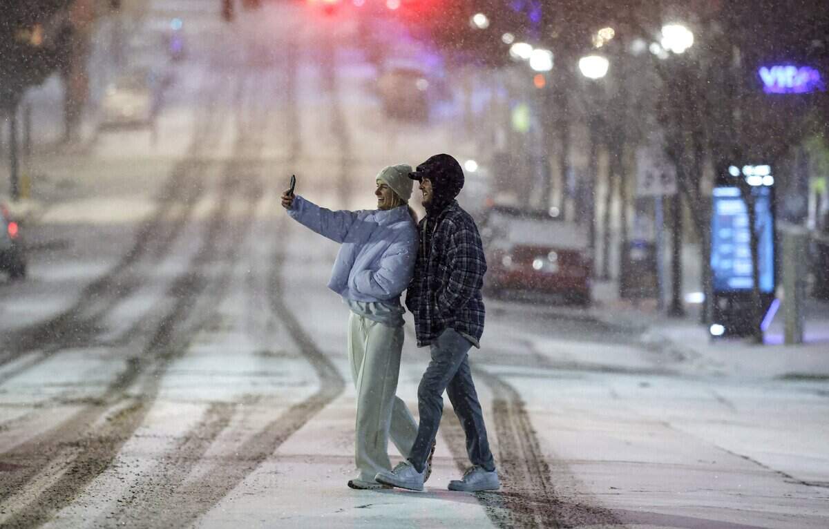 A couple take a selfie in Glenwood South in Raleigh, N.C., Saturday evening, Jan. 31, 2026.