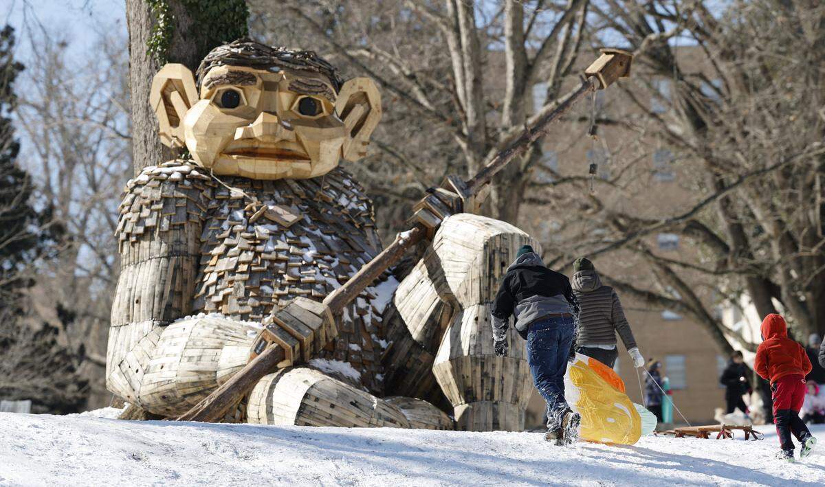 Sledders walk past Thomas Dambo’s Daddy Bird Eye troll at Dix Park in Raleigh, N.C., Sunday, Feb. 1, 2026.
