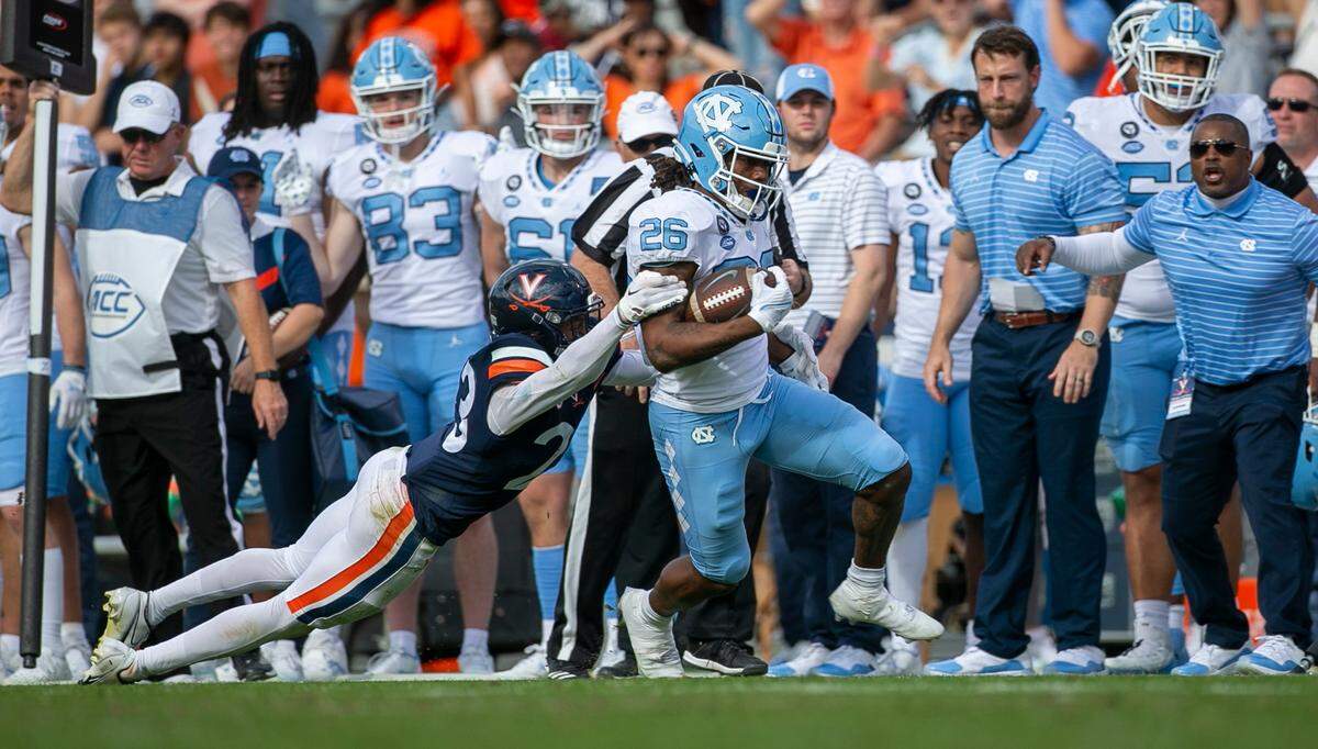 Virginia’s Fentrell Cypress II (23) works to stop North Carolina’s D. J. Jones (26) after a 14-yard pass reception from quarterback Drake Maye in the third quarter on Saturday, November 5, 2022 at Scott Stadium in Charlottesville, Va.