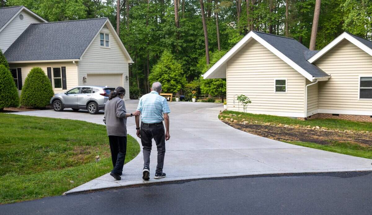 Abby and Bob Millhuaser return to their 940 sq. ft. accessory dwelling unit, built just feet from Abby’s daughter’s residence on Alloway Court after a short stroll in the neighborhood on Friday, April 19, 2024 in Raleigh, N.C.