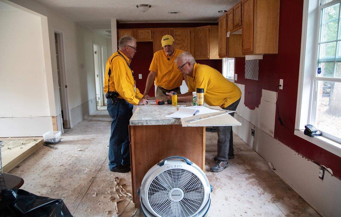 From left, Larry High, executive director Richard Brunson and Bill Martin of the NC Baptist Men go over plans to repair a home damaged by flooding from Hurricane Florence Thursday, Nov. 1, 2018 in Lumberton.