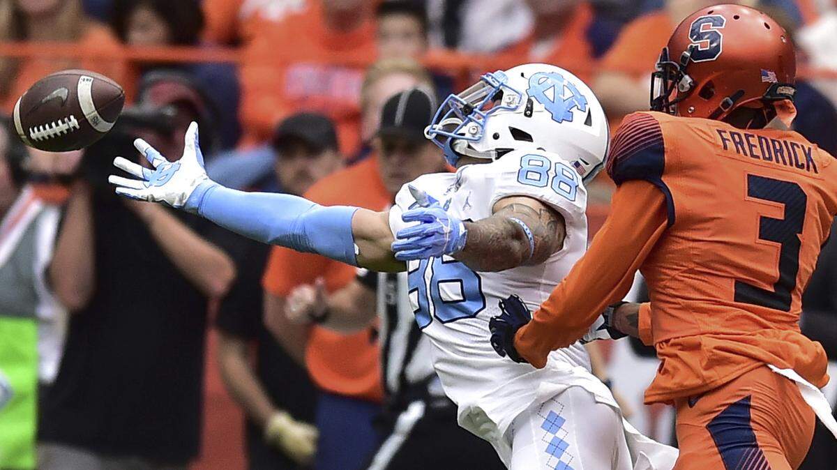 Syracuse defensive back Christopher Fredrick (3) breaks up a pass intended for North Carolina’s Beau Corrales (88).