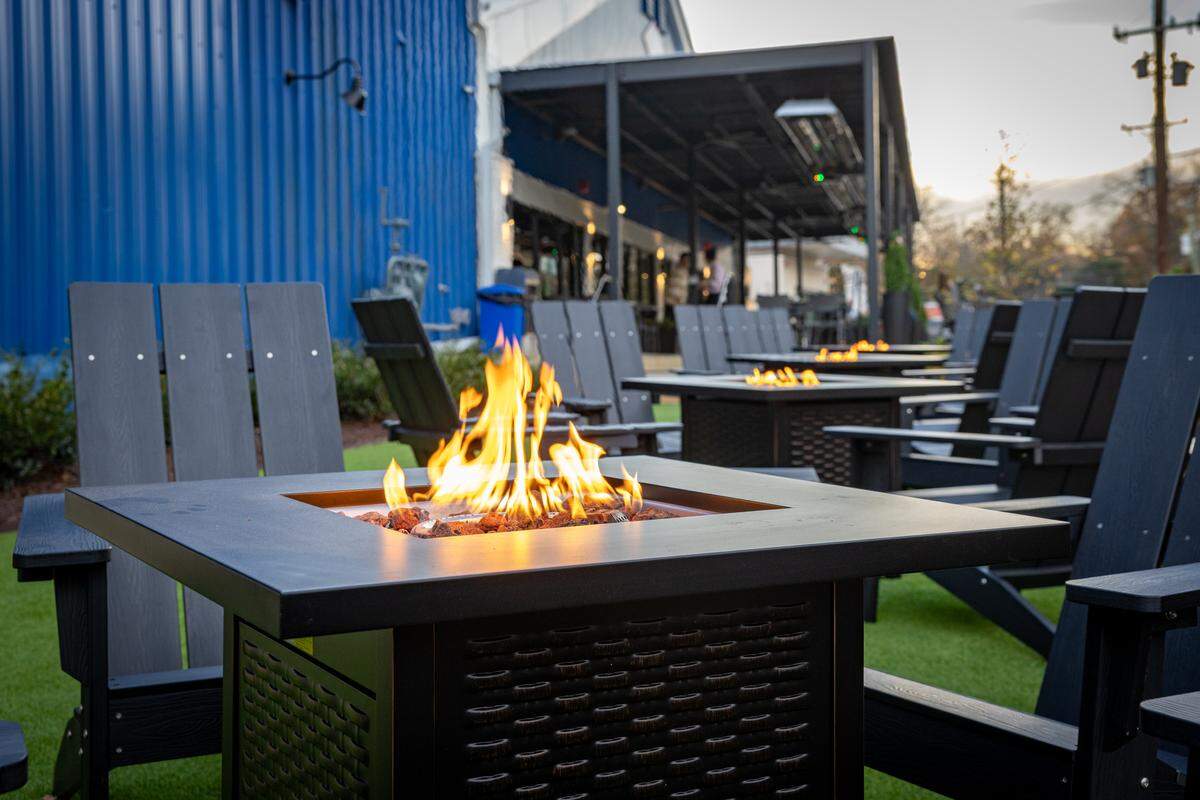 A line of fire pits sits out front of the new Trophy Five Points location.
