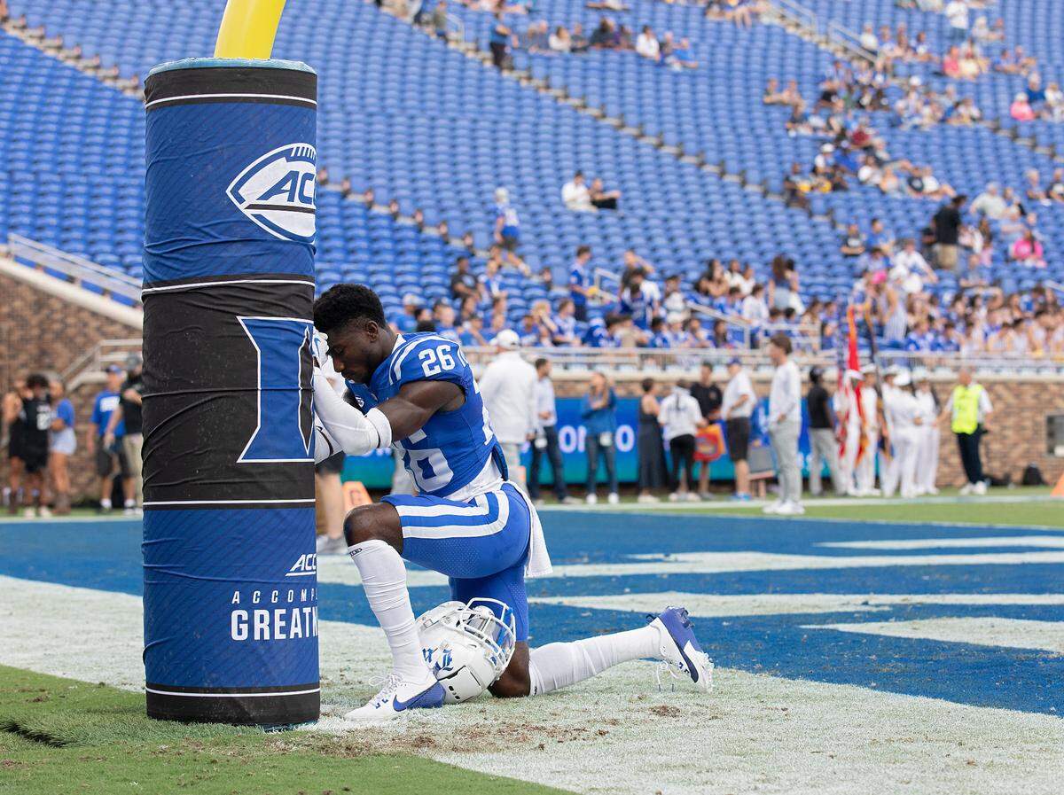 Duke’s Joshua Pickett kneels at the goalpost prior to the Blue Devils’ game against UConn on Saturday, Sept. 14, 2024, at Wallace Wade Stadium in Durham, N.C.