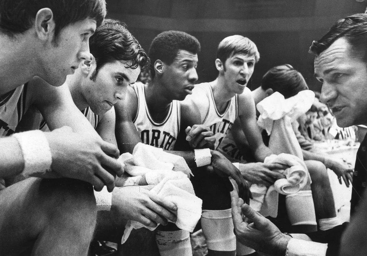 UNC Coach Dean Smith, right, coaches his team, including Eddie Fogler (2nd from left), and Charlie Scott,  during the 1969 ACC tournament. News & Observer File Photo