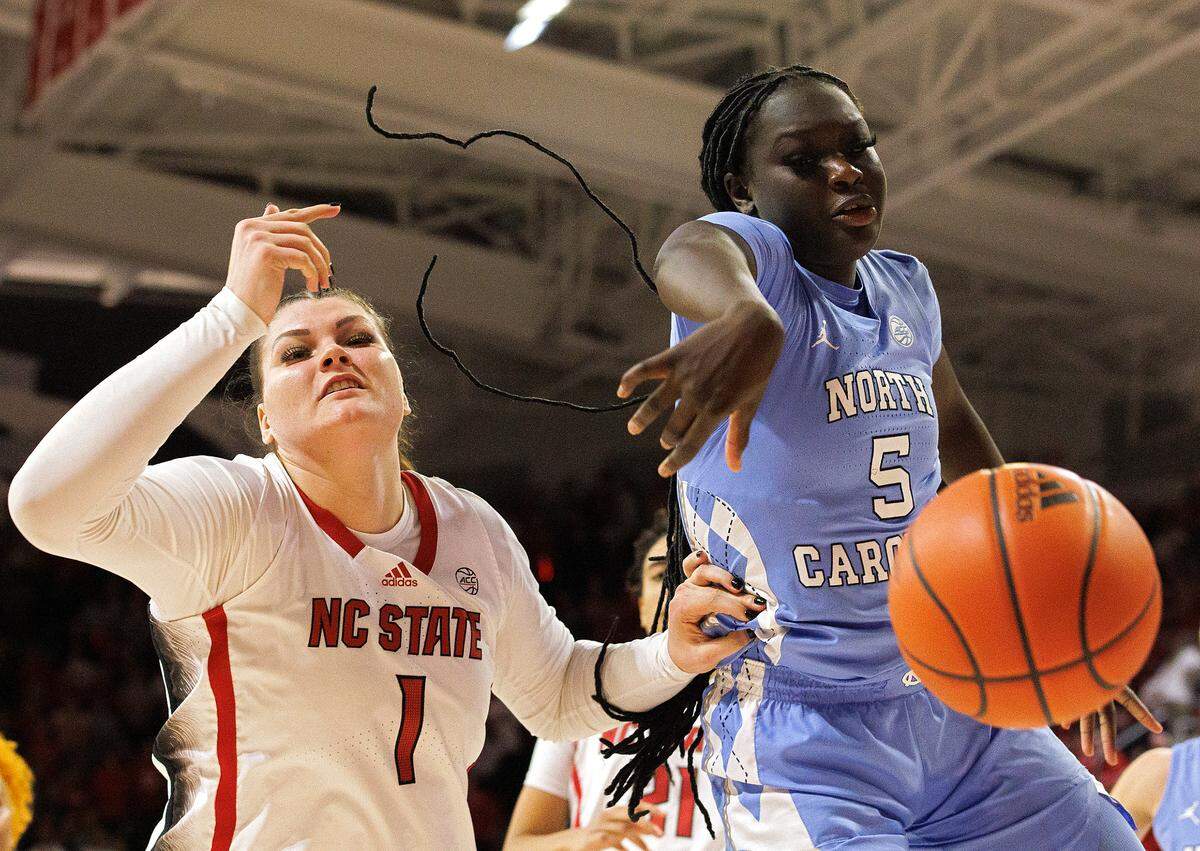 N.C. State’s River Baldwin and North Carolina’s Maria Gakdeng battle for a rebound during the second half of the Wolfpack’s 63-59 win on Thursday, Feb. 1, 2024, at Reynolds Coliseum in Raleigh, N.C.
