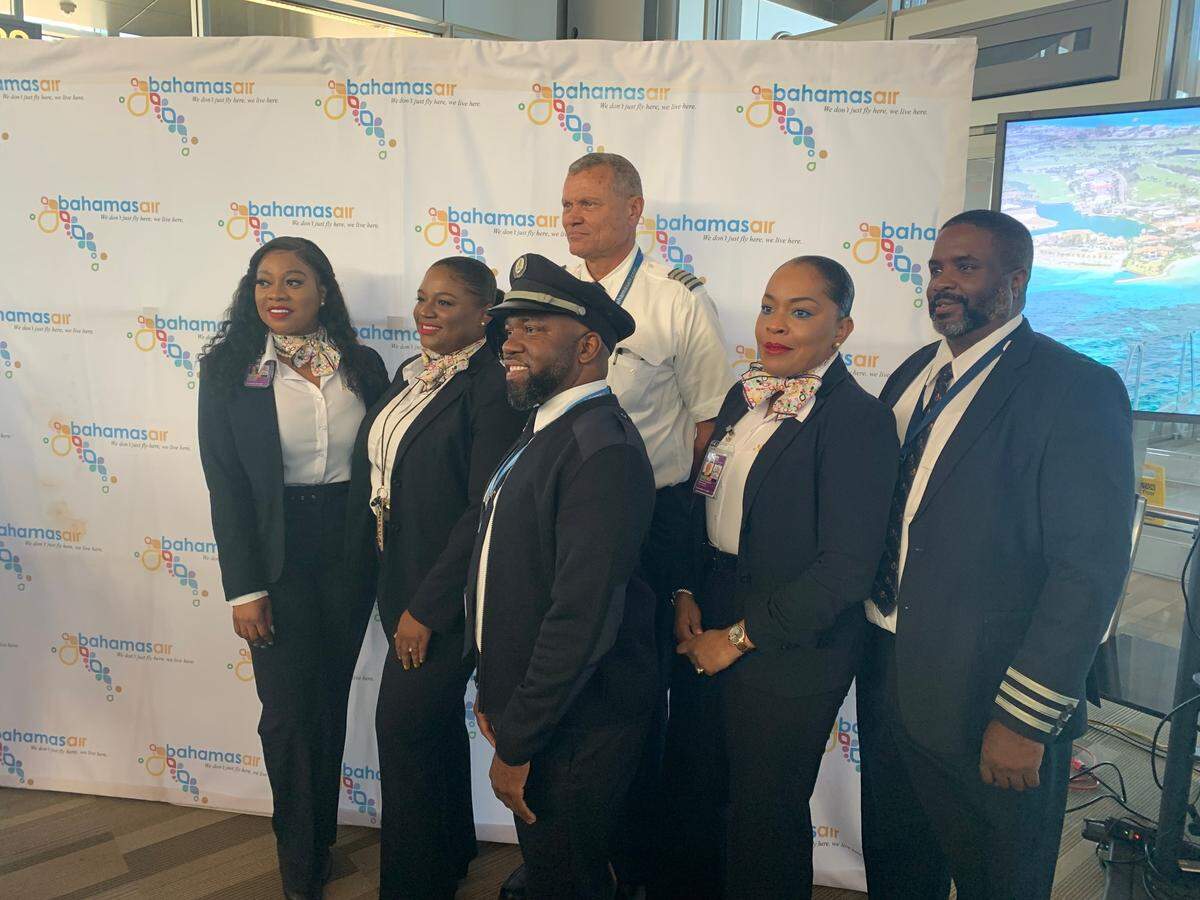 The flight crew of Bahamasair’s inaugural flight from Raleigh-Durham International Airport poses for photos in RDU’s Terminal 2 on Thursday, Nov. 17, 2022.