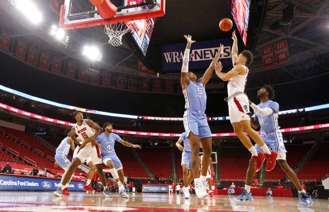 N.C. State’s Devon Daniels (24) shoots as North Carolina’s Armando Bacot (5) defends during N.C. State’s 79-76 victory over UNC at PNC Arena in Raleigh, N.C., Tuesday, December 22, 2020.
