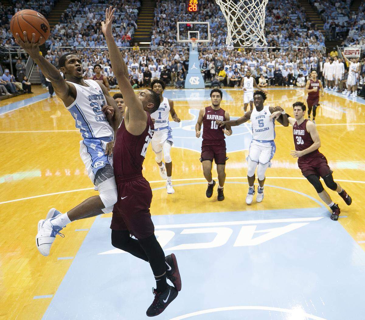 North Carolina’s Kenny Williams (24) drives against Harvard’s Justin Bassey (20) during the second half on Wednesday, January 2, 2019 at the Smith Center in Chapel Hill, N.C. Williams scored 11 points in the Tar Heels’ win.