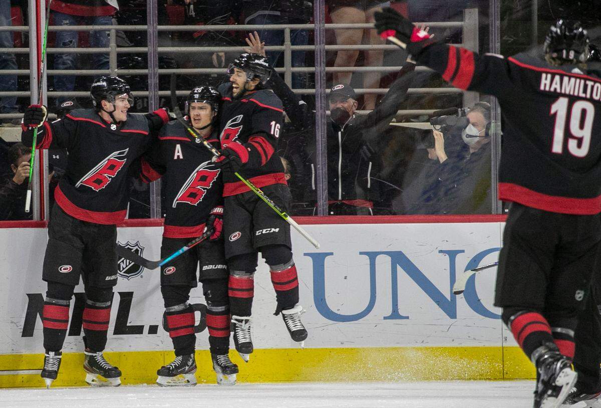 Carolina Hurricanes’ Sebastian Aho (20) celebrates with Vincent Trocheck (16) and Andrei Svechnikov (37) after scoring in the first period to give the Hurricanes a 1-0 lead over Nashville during game two of their first round Stanley Cup playoff series on Wednesday, May 19, 2021 at PNC Arena in Raleigh, N.C.