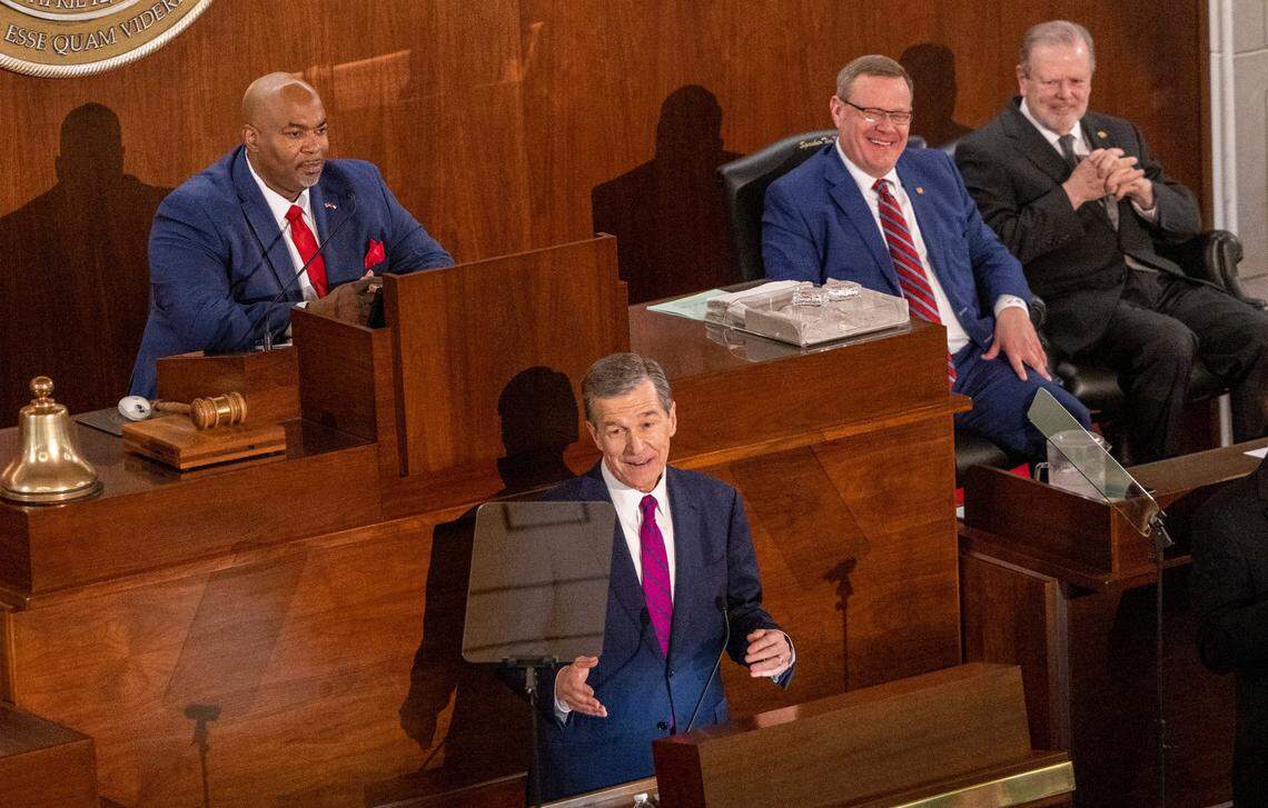 Gov. Roy Cooper delivers his State of the State address to a joint session of the N.C. General Assembly on Monday, March 6, 2023 as, from left, Lt. Gov. Mark Robinson, House Speaker Tim Moore and Senate Leader Phil Berger look on.