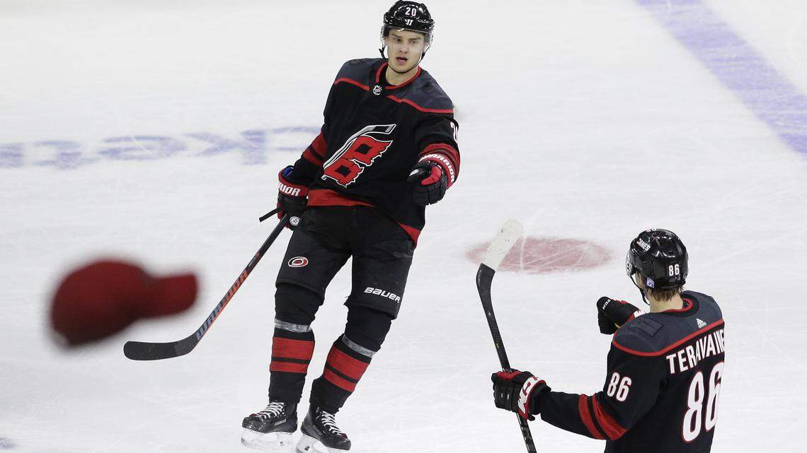 Carolina Hurricanes’ Sebastian Aho (20), of Finland, is congratulated by Teuvo Teravainen (86), also of Finland, after his hat trick during the third period of an NHL hockey game against the Nashville Predators in Raleigh, N.C., Sunday, Jan. 13, 2019. (AP Photo/Gerry Broome)