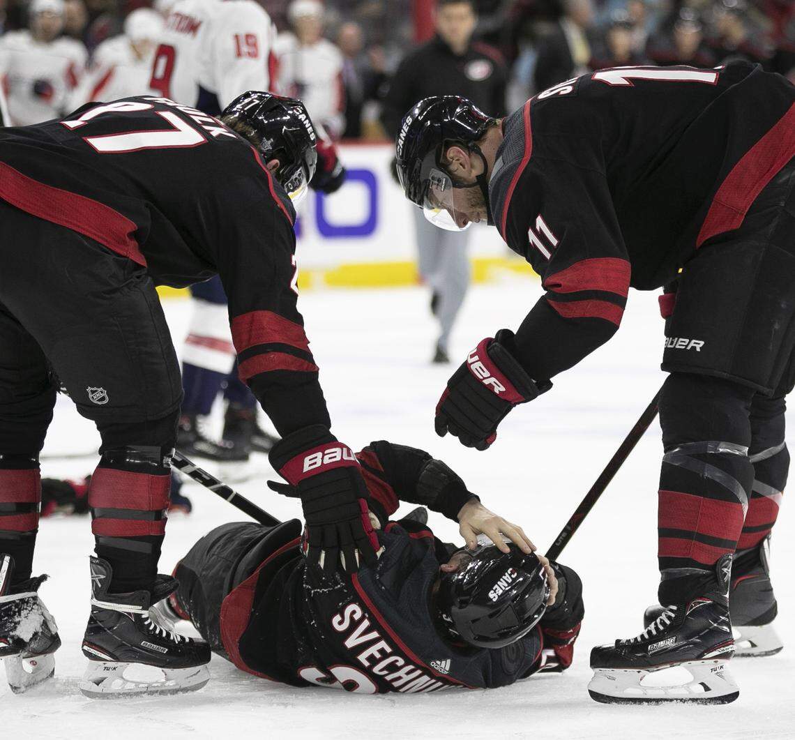 Carolina Hurricanes’ Justin Faulk (27) and Jordan Staal (11) attend to teammate Andrei Svechnikov (37) who was knocked to the ice during a fight with Washington’s Alex Ovechkin during the first period on Monday, April 15, 2019 at the PNC Arena on Raleigh, N.C.