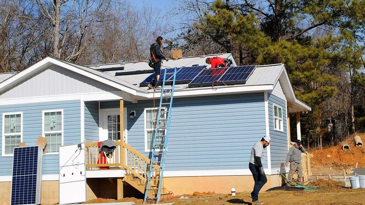 Habitat for Humanity volunteers install solar panels on a new home in Orange County. The nonprofit housing agency received a $100,000 county climate action grant in 2023 to add solar panels to 14 new homes in Chapel Hill and Hillsborough.