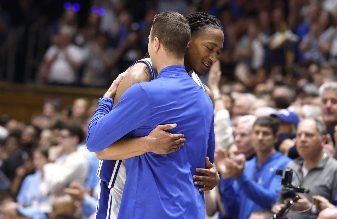 Duke head coach Jon Scheyer hugs Duke’s Maliq Brown (6) as he comes off the court in the final seconds of Duke’s 76-61 victory over UNC at Cameron Indoor Stadium in Durham, N.C., Saturday, March 7, 2026.