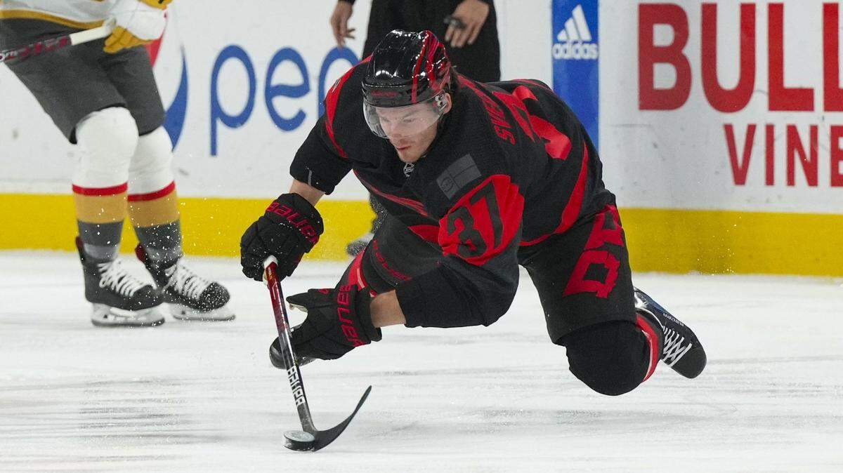 Carolina Hurricanes right wing Andrei Svechnikov (37) falls while skating with the puck against the Vegas Golden Knights during the first period at PNC Arena.