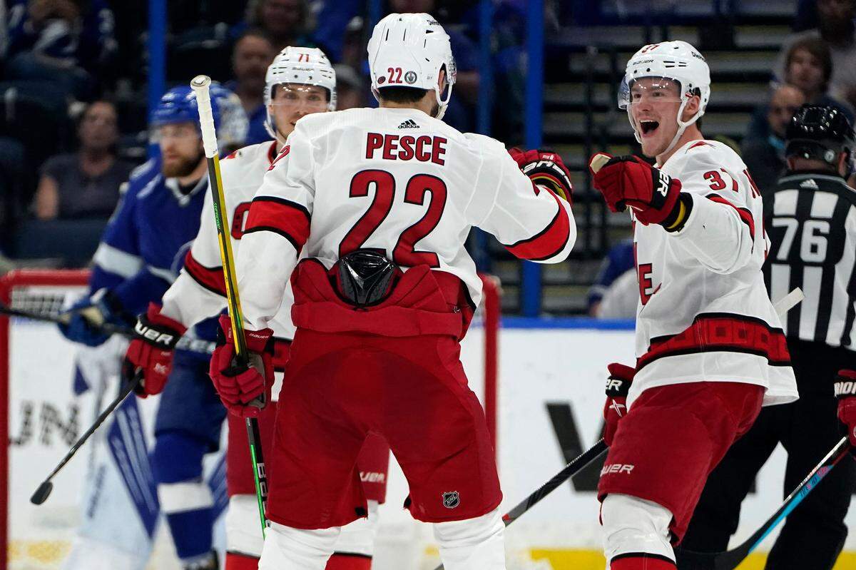 Carolina Hurricanes defenseman Brett Pesce (22) celebrates his goal against the Tampa Bay Lightning with right wing Andrei Svechnikov (37) during the second period in Game 3 of an NHL hockey Stanley Cup second-round playoff series Thursday, June 3, 2021, in Tampa, Fla. (AP Photo/Chris O’Meara)