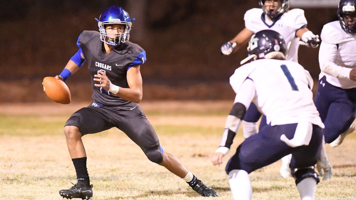 Mateo Sudipo, left, of Wake Forest looks for a pass against David Sohn, right, of Leesville Road. The Leesville Road Pride visited the Wake Forest Cougars in a high school football game on November 30, 2018.