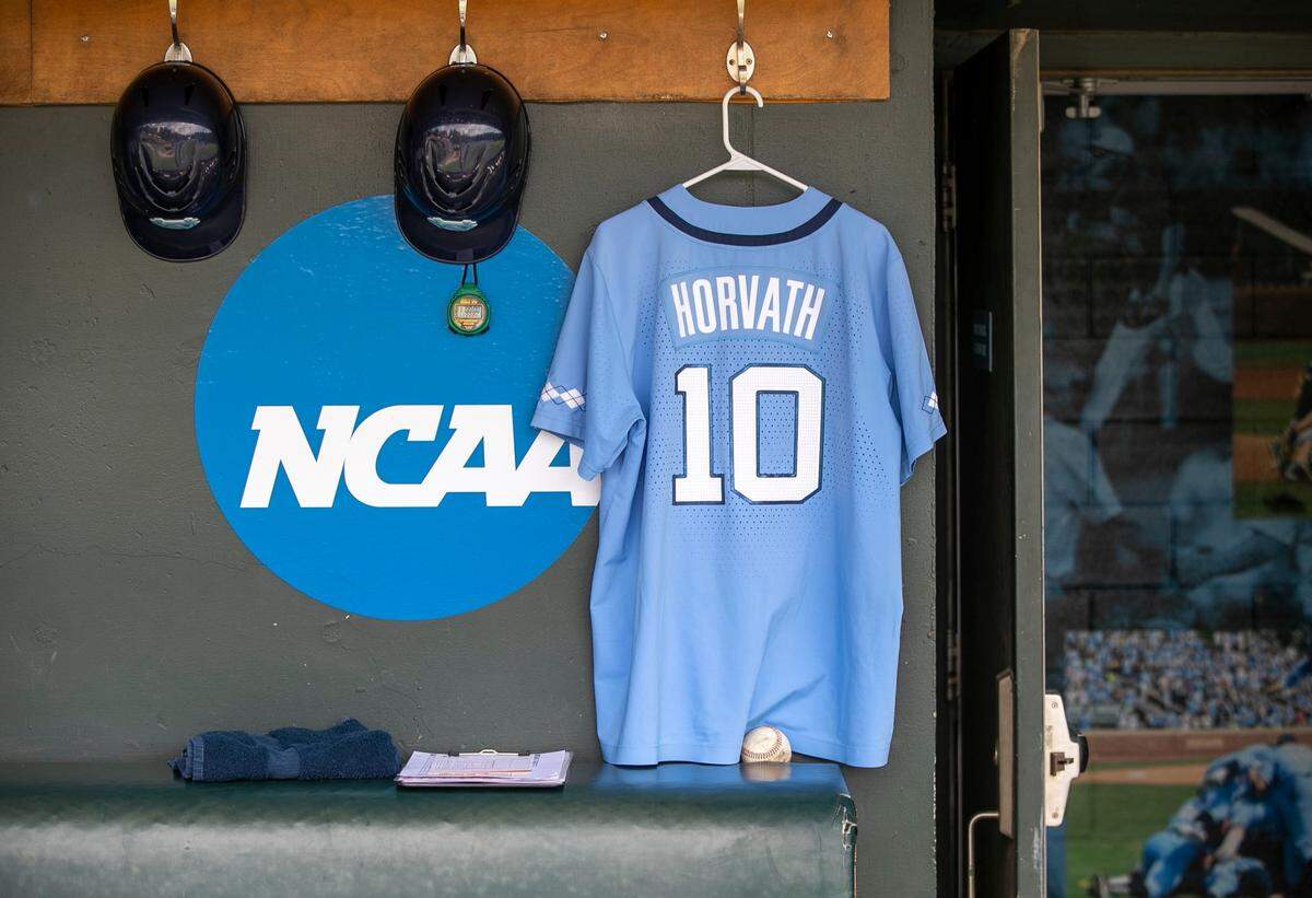 The unifrom of North Carolinas Mac Horvath (10) hangs in the Tar Heels dugout prior to their game against Arkansas on Sunday, June 12, 2022 at Boshamer Stadium in Chapel Hill, N.C. Horvath will miss the game after having emergency appendectomy surgery last night.