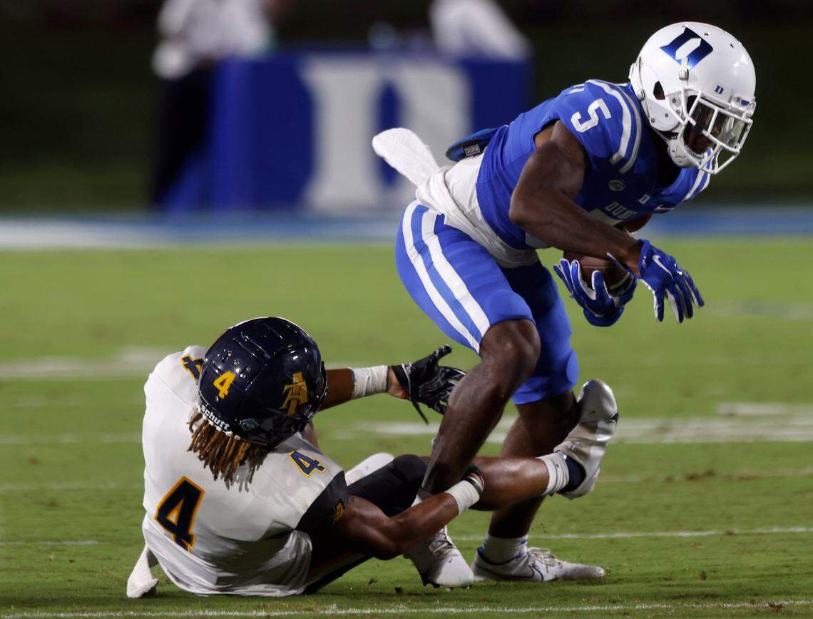 Duke Blue Devils wide receiver Jalon Calhoun carries the ball past North Carolina A&T Aggies defensive back Aaron Harris during the second half of Dukes game against North Carolina A&T at Wallace Wade Stadium in Durham, N.C. on Saturday, Sept. 17, 2022.