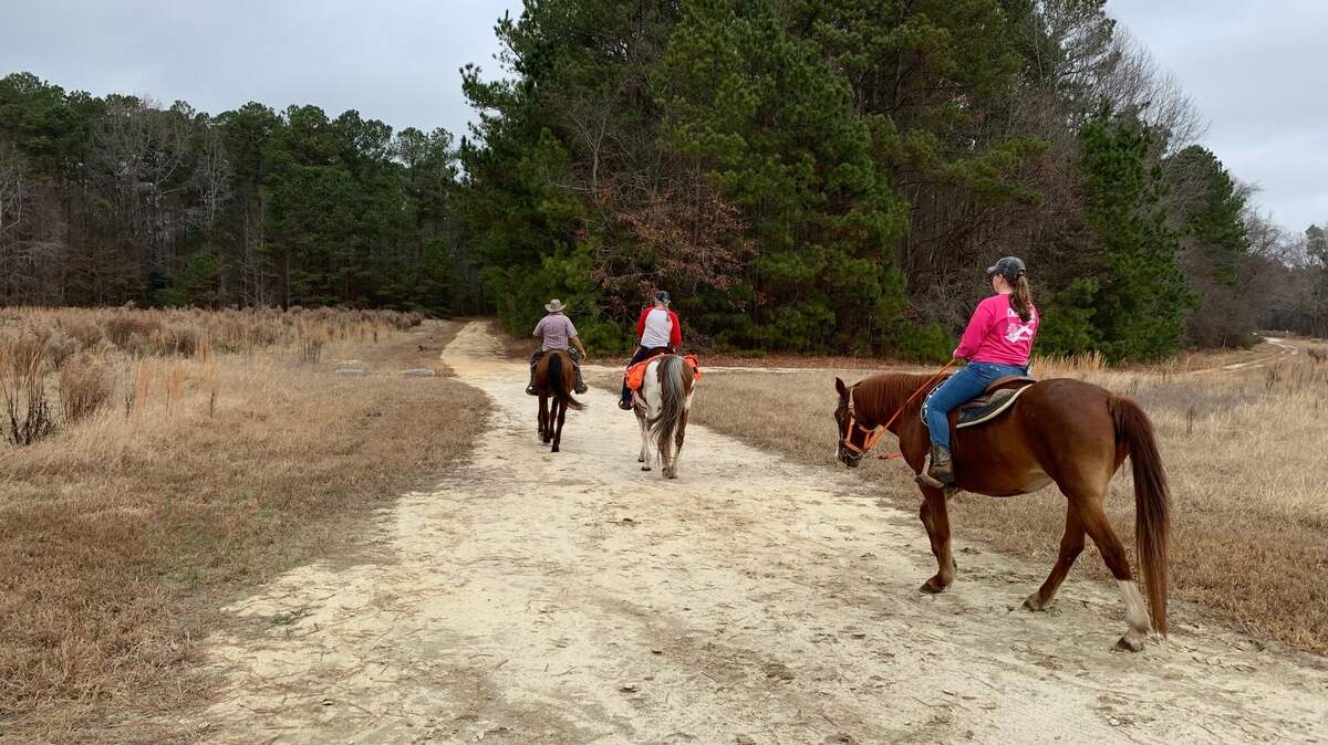 Lisa and Kenneth Bedford and their granddaughter Summer, all of Goldsboro, head out for a ride at Sandy Pines Preserve near Wendell on Saturday, Dec. 18, 2021.
