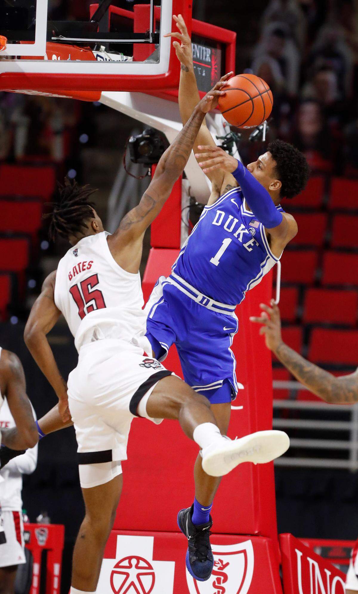 N.C. State’s Manny Bates (15) blocks the shot by Duke’s Jalen Johnson (1) during the first half of N.C. State’s game against Duke at PNC Arena in Raleigh, N.C., Saturday, February 13, 2021.