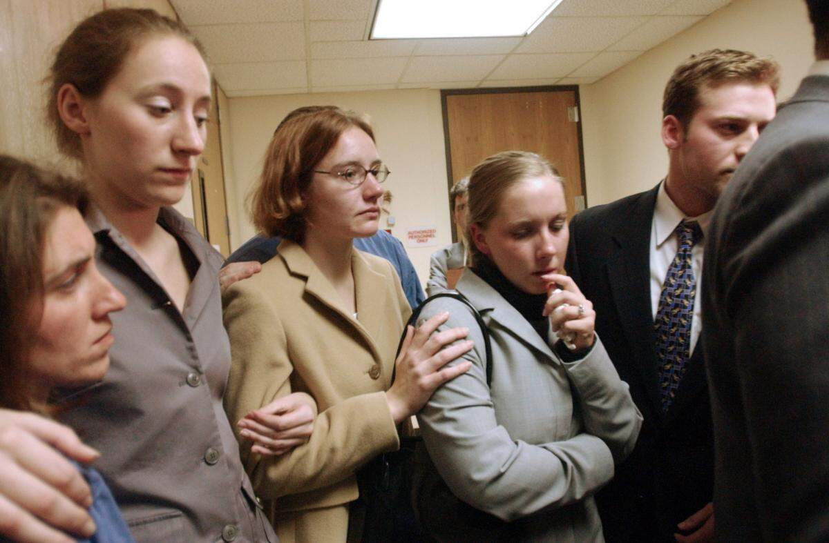 Michael and Kathleen Peterson’s children leave the courtroom after his first court appearance Dec. 21, 2001. From second from left: Margaret and Martha Ratliff, Caitlin Atwater and son Todd Peterson.