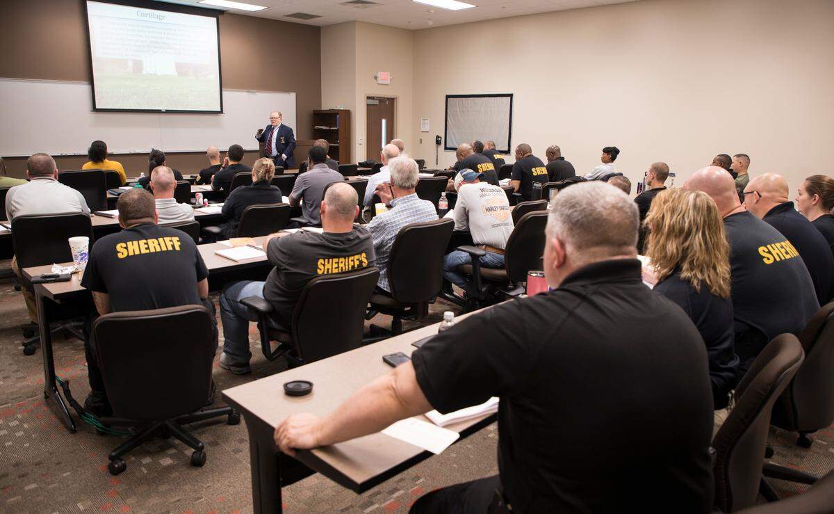 Sheriff’s deputies listen to Wake County Sheriff’s Office legal counsel, James Rick Brown, give a training session addressing changes policies at the Wake County Law Enforcement Training Center in 2019.