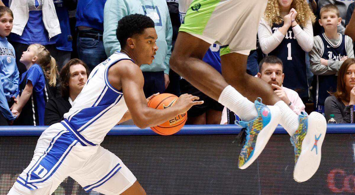 Duke’s Caleb Foster (1) drives by Queens’ Deyton Albury (13) during the second half of Duke’s 106-69 victory over Queens University at Cameron Indoor Stadium in Durham, N.C., Saturday, Dec. 30, 2023.