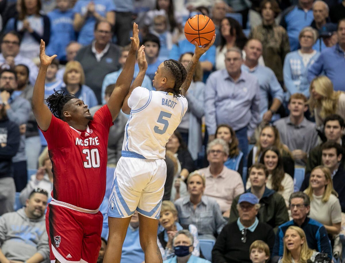 North Carolina’s Armando Bacot (5) puts up a shot against N.C. State’s D.J. Burns (30) during the first half on Saturday, January 21, 2023 at the Smith Center in Chapel Hill, N.C. Bacot scored 23 points and secured 18 rebounds.