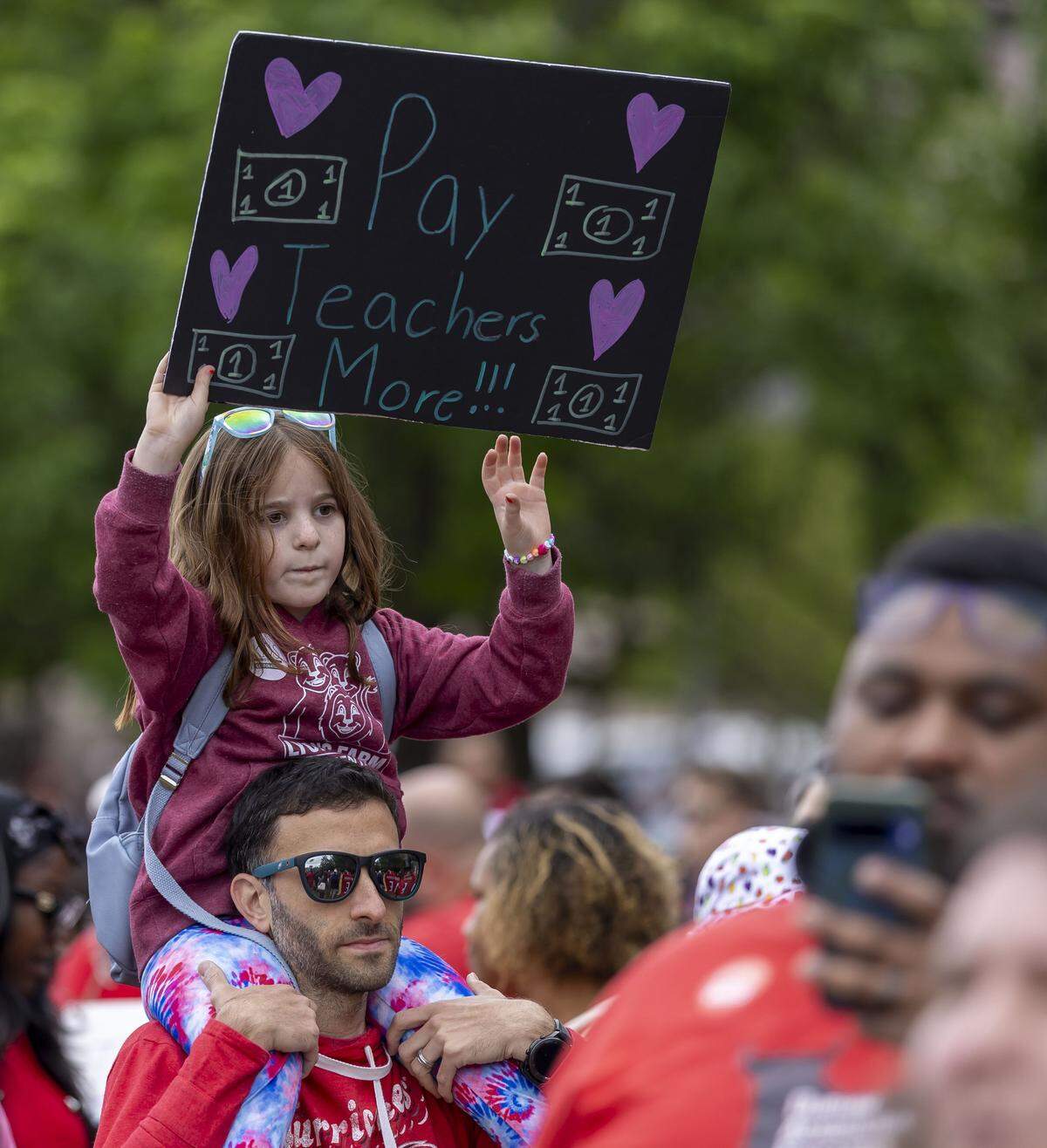 Sean Cacciabaudo and his daughter Mattea Cacciabaudo attend the May Day protest on the Halifax Mall, calling for higher teacher pay, and an end to corporate tax breaks and private school vouchers, on Friday, May 1, 2026 in Raleigh, NC.