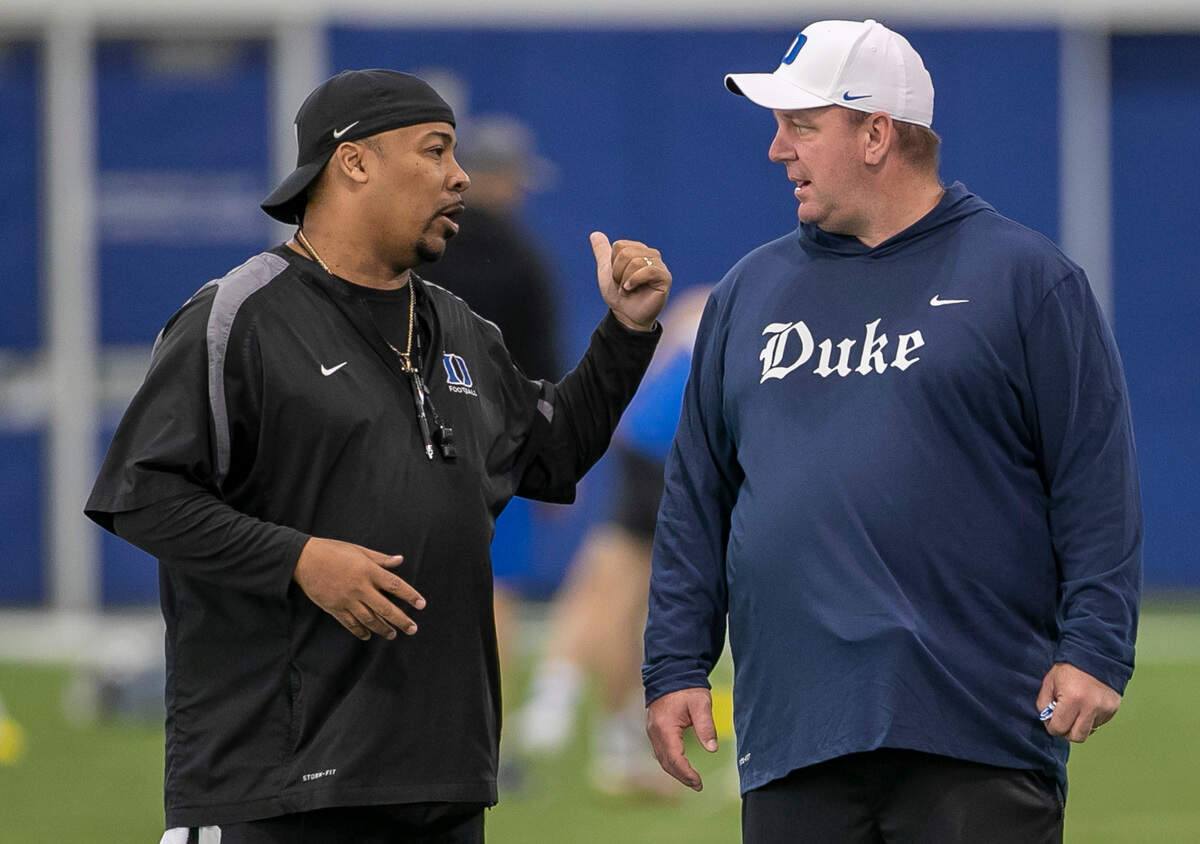 Duke associate head coach Trooper Taylor talks with head coach Mike Elko during the Blue Devils’ spring practice on Friday, March 24, 2023 in Durham, N.C.