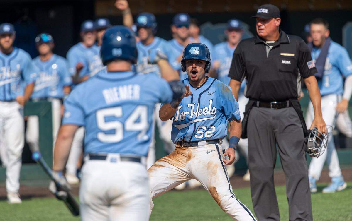 North Carolina’s Tomas Frick (52) scores on a wild pitch by Arkansas pitcher Brady Tygart (25) in the seventh inning to tie Arkansas 2-2 in game two of their NCAA Super Regional series on Sunday, June 12, 2022 at Boshamer Stadium in Chapel Hill, N.C.