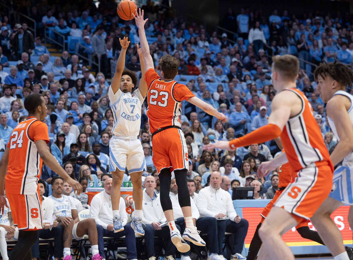 North Carolina’s Seth Trimble (7) launches a three-point shot over Syracuse’s Quadir Copeland (24) in the first half on Saturday, January 13, 204 at the Smith Center in Chapel Hill, N.C.