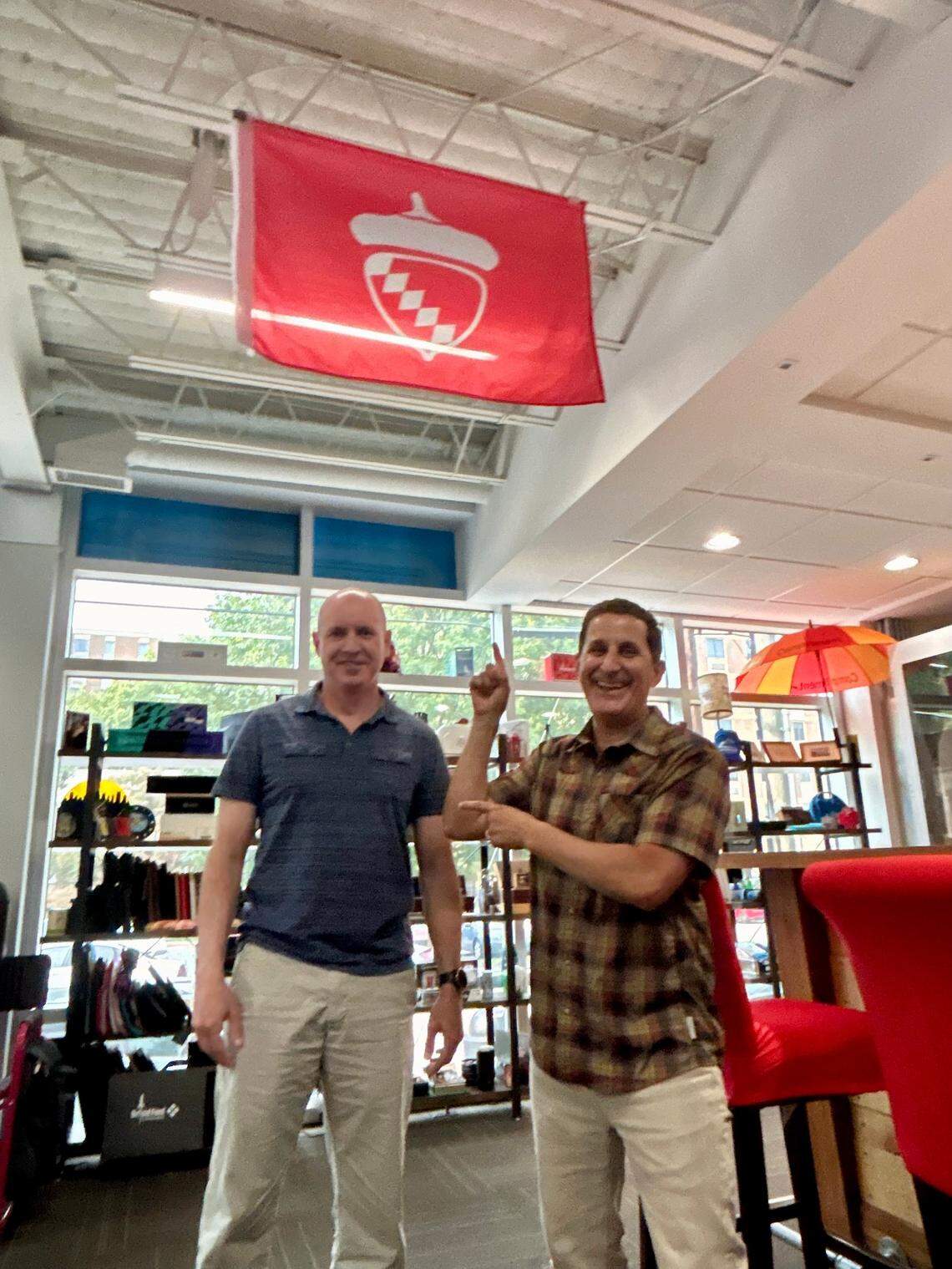 Brian Rineer, left, and Danny Rosin show off the new Raleigh flag design they hope the city will officially adopt.