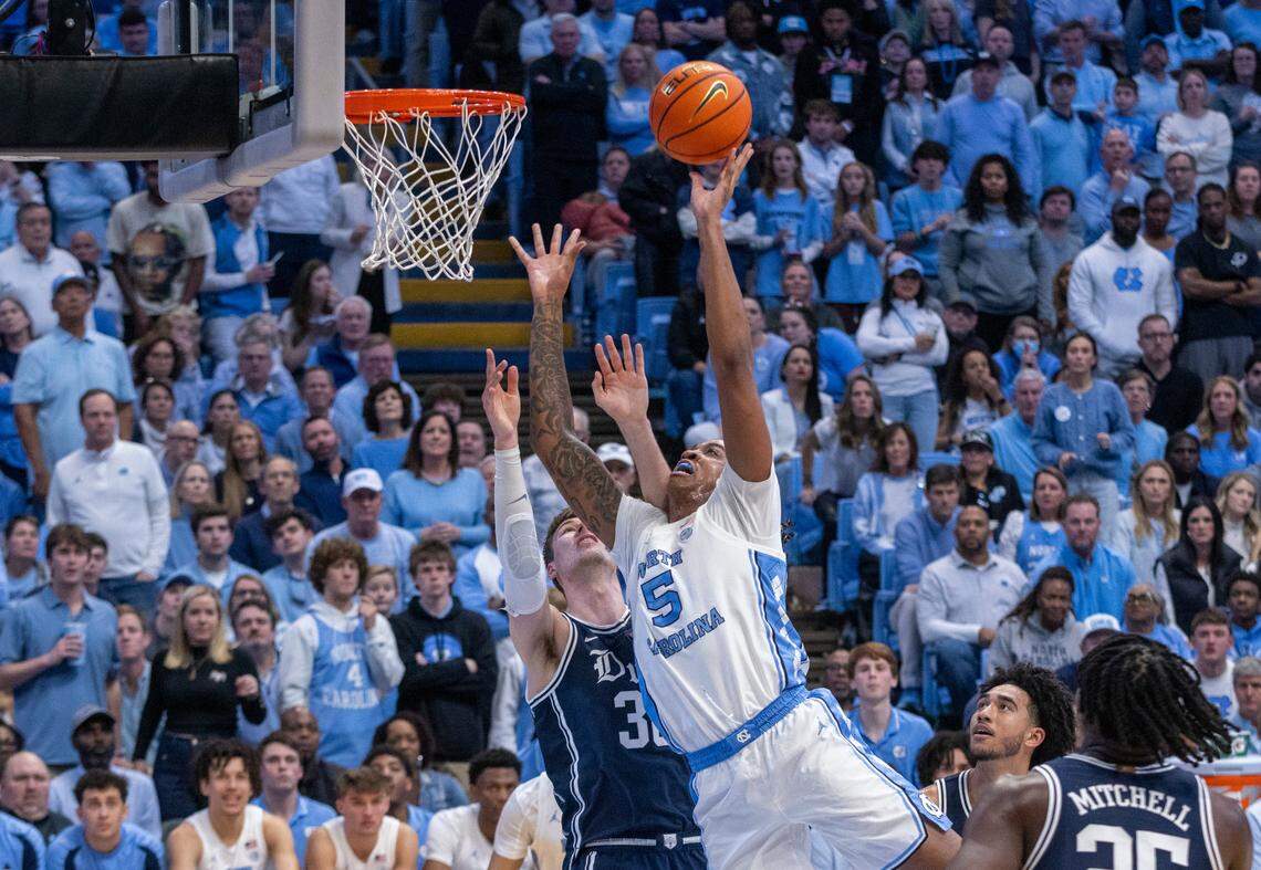 North Carolina’s Armando Bacot (5) muscles his way to the basket against Duke’s Kyle Filipowski (30) in the second half on Saturday, February, 3, 2024 at the Dean E. Smith Center in Chapel Hill, N.C. Bacot led all scores with 25 points in the Tar Heels’ 93-84 victory.