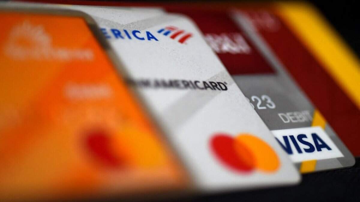 This illustration picture shows debit and credit cards arranged on a desk on April 6, 2020 in Arlington, Virginia - As restaurants risk dramatic drops in sales or outright closure amid the COVID-19 pandemic, some businesses are encouraging customers to pay with credit or debit card, while others are introducing no cash policies to limit the exchange of germs during transactions. (Photo by Olivier DOULIERY / AFP) (Photo by OLIVIER DOULIERY/AFP via Getty Images)
