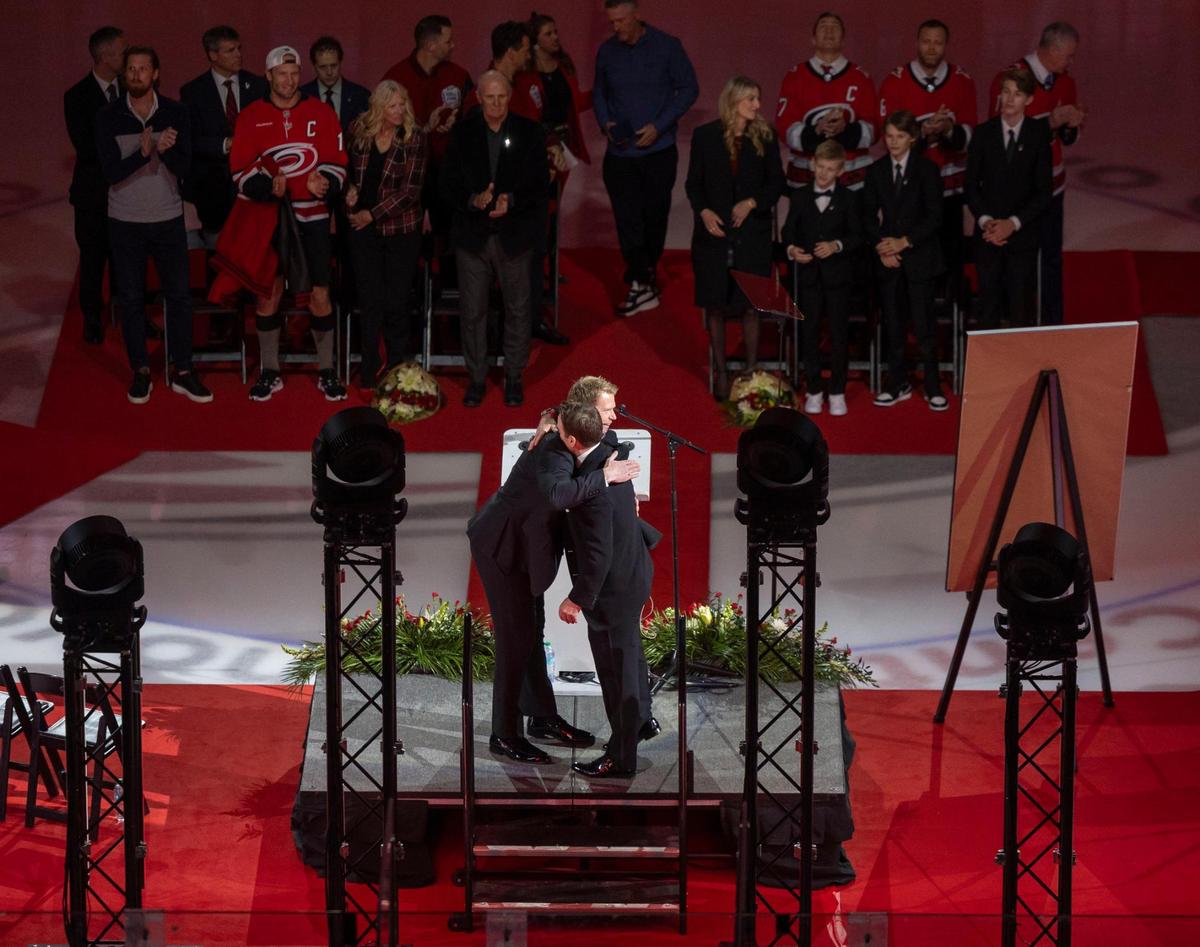 Eric Staal embraces Tripp Tracy during the retirement of his jersey ceremony on Sunday, January 12, 2025 at Lenovo Center in Raleigh, N.C.