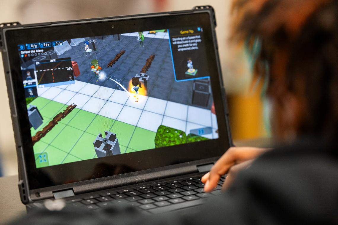 A Wake County middle school student plays Plasma Games’ ”SciOps: Global Defense” video game during science class.