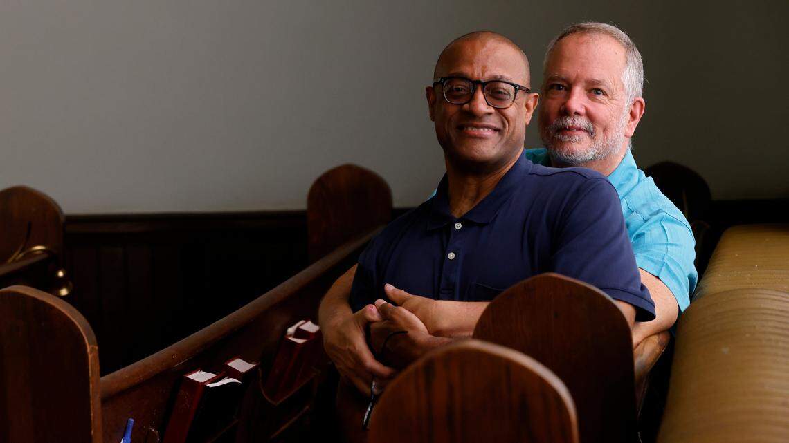 Maxie and Mark Hipps-Figgs are photographed in the sanctuary of Elizabeth Street United Methodist Church on Sunday, July 31, 2022, in Durham, N.C. The Hipps-Figgs were the first gay couple to be publicly married in a North Carolina United Methodist Church.