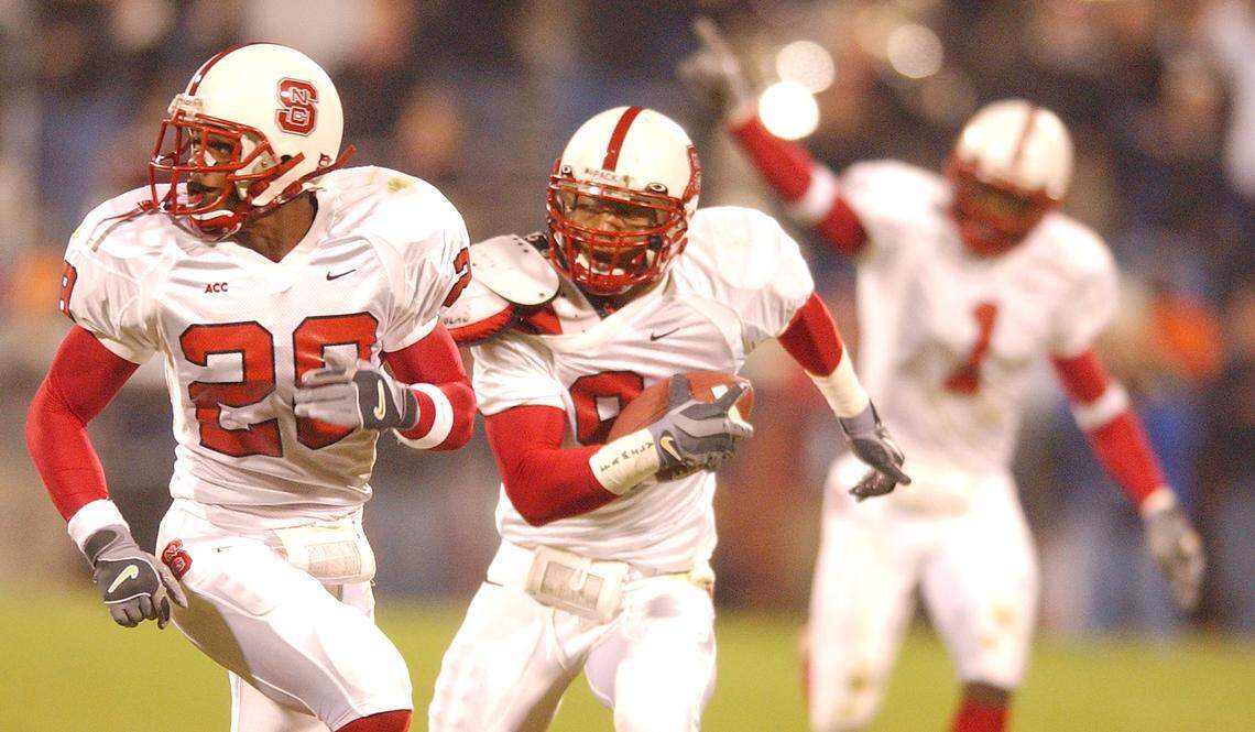 N.C. State’s Terrence Holt (9) heads towards the end zone with Lamont Reid (28) after he picked up a blocked Clemson punt, returning it for a touchdown, during the Wolfpack’s 38-6 victory in 2002.