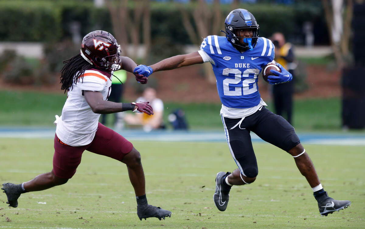 Duke Blue Devils running back Jaylen Coleman runs the ball past Virginia Tech Hokies defensive back Nasir Peoples during the second half of a football game at Wallace Wade Stadium on Saturday, Nov. 12, 2022, in Durham, N.C.