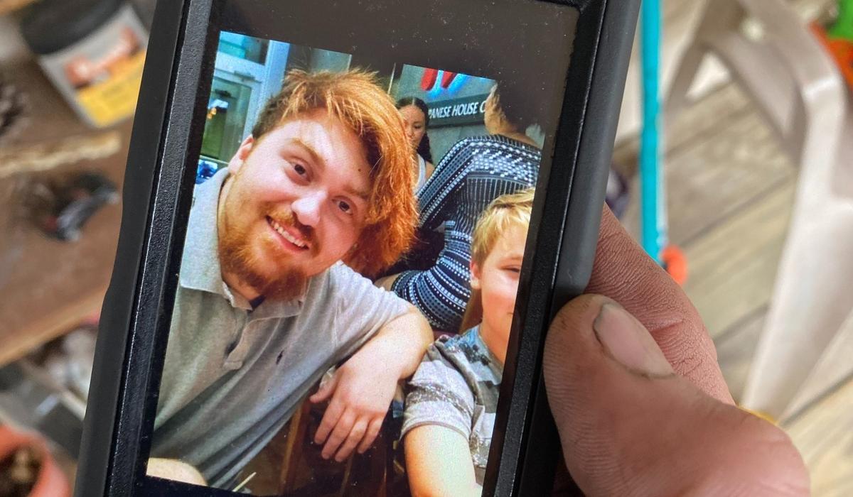 Dylan Wall, 23, was shot and killed on his UPS route in Raleigh Wednesday, Feb. 10, 2021. His father, Phillip, shows this picture from his phone.