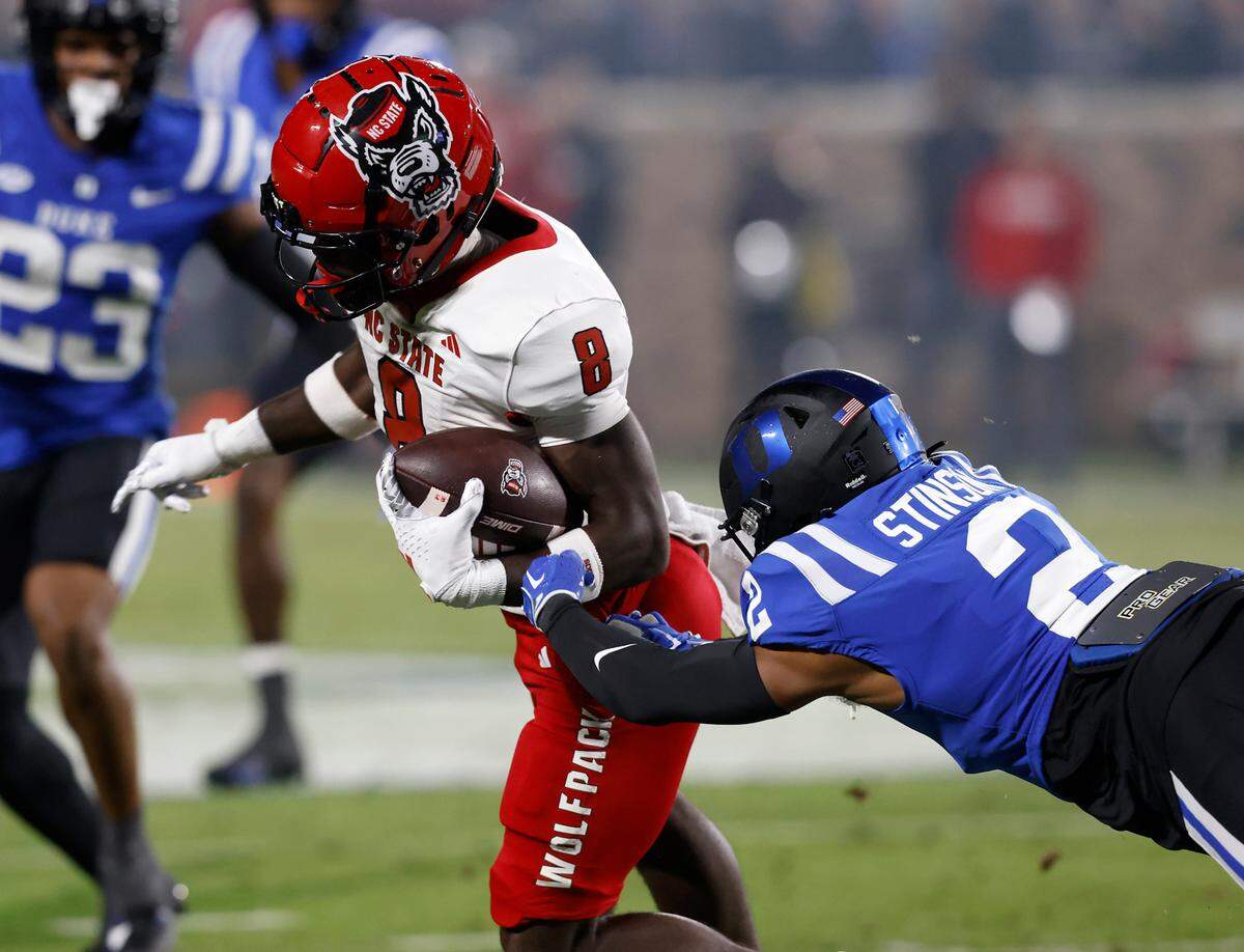 N.C. State’s Julian Gray runs the ball beyond the reach of Duke’s Jaylen Stinson during the first half of the Blue Devils’ 24-3 win on Saturday, Oct. 14, 2023, at Wallace Wade Stadium in Durham, N.C.