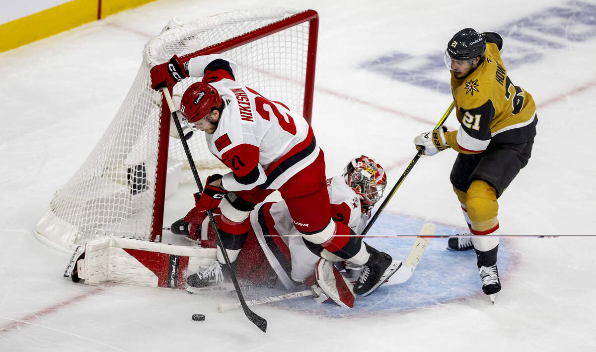 Carolina Hurricanes Alexander Nikishin (21) clears the puck after a scoring attempt on Frederik Andersen (31) by Vegas center Brett Howden (21) in the second period in Game 3 of the Stanley Cup Final, on Saturday, June 6, 2026 at T-Mobile Arena in Las Vegas, NV.