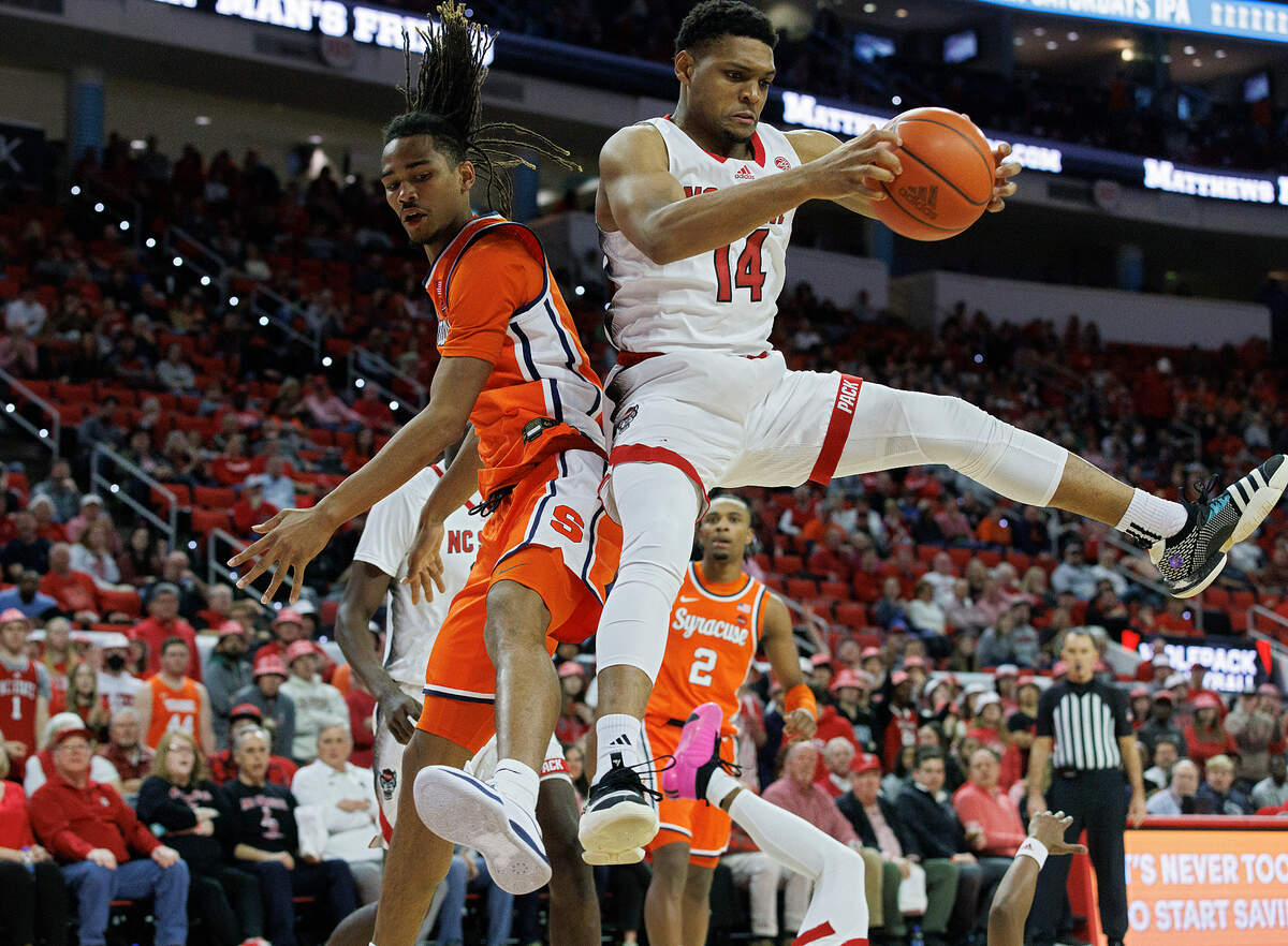 N.C. State’s Casey Morsell pulls down a rebound away from Syracuse’s Chris Bell during the second half of the Wolfpack’s 87-83 loss on Tuesday, Feb. 20, 2024, at PNC Arena in Raleigh, N.C.